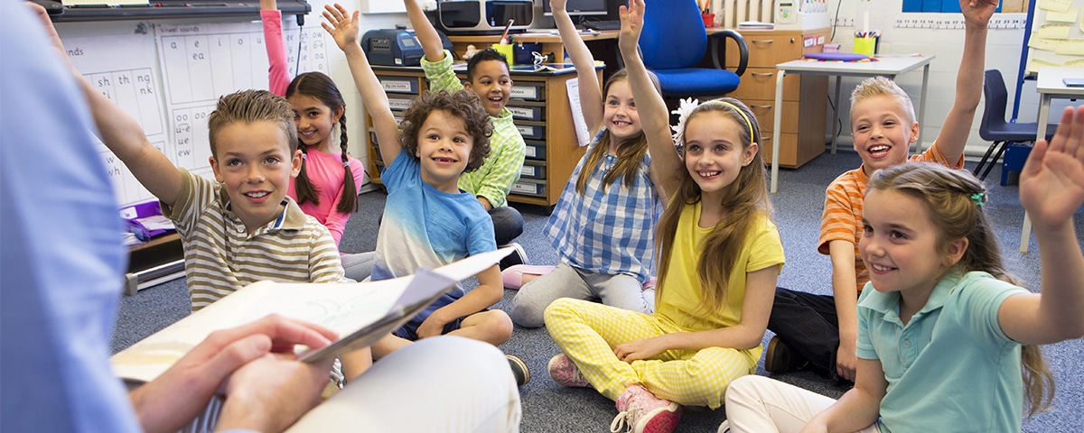 students raising hands